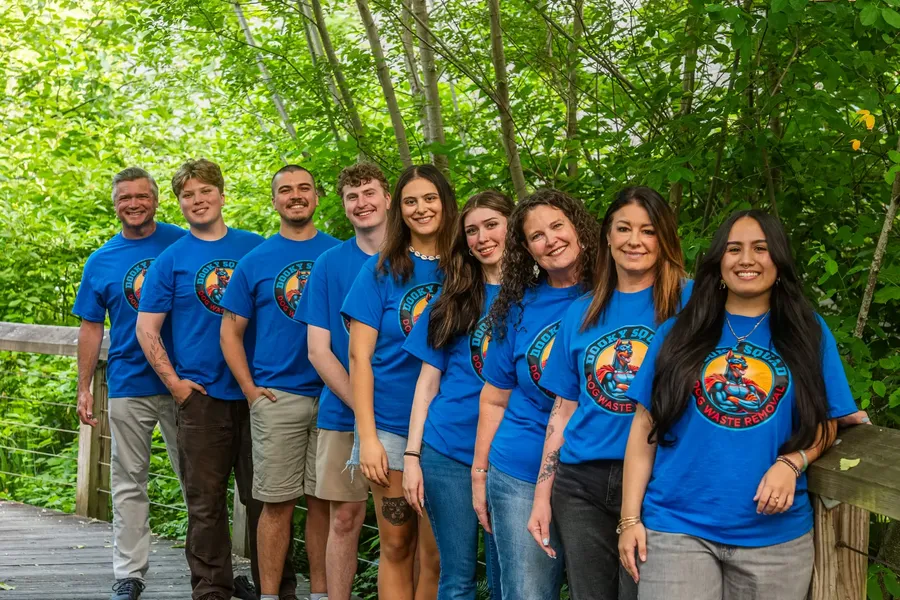 The Dooky Squad crew in branded shirts, with Marquis Pounds at the left